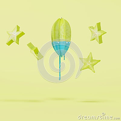 Starfruit dripping in blue paint and floating pieces of starfruit on pastel yellow background Stock Photo