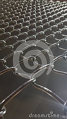 Staring up at a long chain link fence Stock Photo