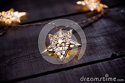 Starry Christmas lights on a gray wooden background Stock Photo