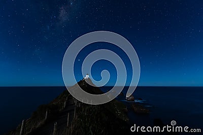 Starry night at Nugget Point Lighthouse, New Zealand, under the Milky Way Stock Photo