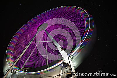 Starry sky behind ferris wheel. Long exposure Stock Photo