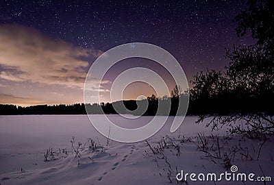 starry sky on a lonely lake in winter Stock Photo