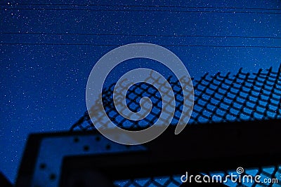 Starry sky and mesh fence Stock Photo