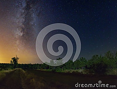 Starry sky with Milky Way galaxy over the summer night rural landscape Stock Photo