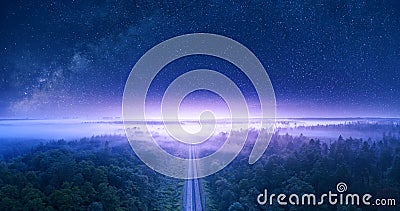 Starry sky over forest and railway view from drone Stock Photo