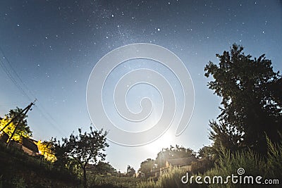 Starry sky in the summer evening over the village. Stock Photo