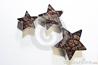 Stars of large, medium and small size on a white background filled with raisins. Free the concept of family. Stock Photo