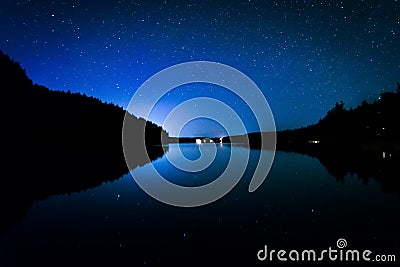 Stars in the night sky reflecting in Echo Lake, at Acadia Nation Stock Photo