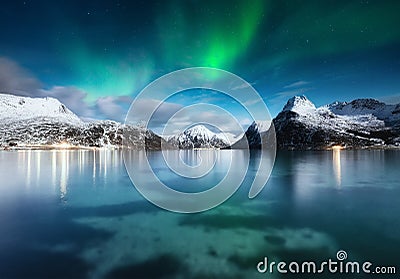 Stars and northern light. Aurora Borealis. Hamnoy village, Lofoten Islands, Norway. Glow on sky. Nature image. Mountains and water Stock Photo