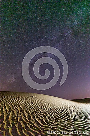 Stars over a sand dune in the desert of Oman Stock Photo