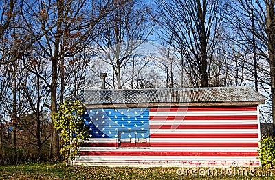 Stars and Stripes flag painted on a rural american house Stock Photo