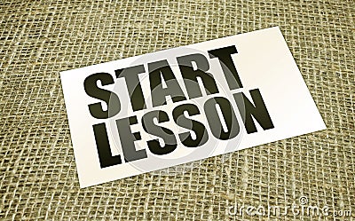 Start lesson words on card on burlap canvas. Education concept Stock Photo