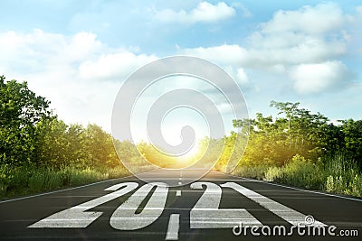 Start new year with fresh vision and ideas. 2021 numbers on asphalt road Stock Photo