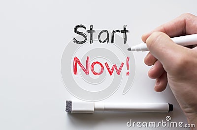 Start now written on whiteboard Stock Photo