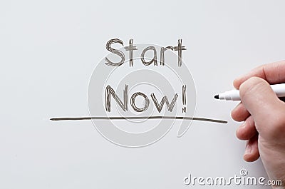 Start now written on whiteboard Stock Photo