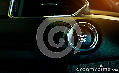 Start stop engine button of luxury car. Push up button for start or stop car engine in keyless automobile. Turn key with ignition Stock Photo
