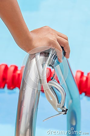 Start swimming race concept with closeup the hand grab on ladder Stock Photo
