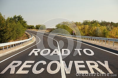 Start to live without alcohol addiction. Phrase ROAD TO RECOVERY on asphalt highway Stock Photo
