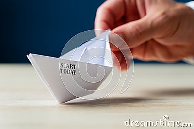 Start today sign on paper made origami boat Stock Photo