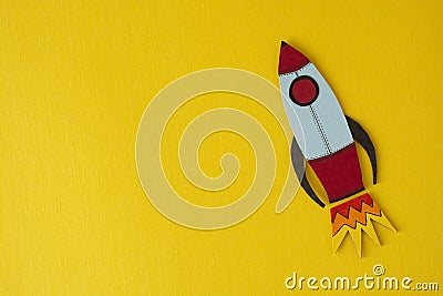 Start up business concept. Boost or increase incomes, salary. Drawn rocket on colorful yellow background. Copy space Stock Photo