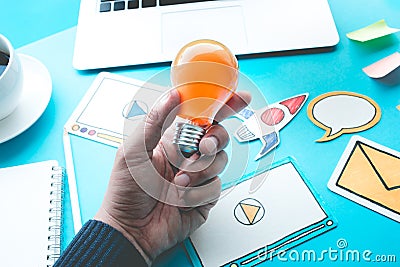 Start up idea concepts with light bulb in male hand Stock Photo