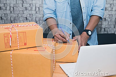 Start up small business entrepreneur SME or freelance asian man working with box at home concept, Young Asian small business owner Editorial Stock Photo