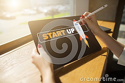 Start up spaceship on device screen. Business and finance concept. Stock Photo