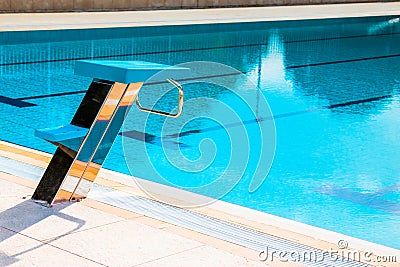 Starting block at the edge of a swimming pool Stock Photo