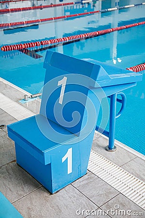 Starting block, number 1, swimming pool with an empty race track. Sport swimming Stock Photo