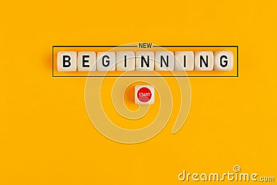 Starting a new beginning concept. The word new beginning on wooden cubes with a start button Stock Photo