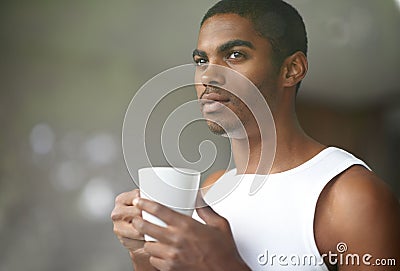 Starting off the morning with a cuppa joe. a young man holding a cup of coffee. Stock Photo