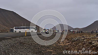 Starting point of the hike to a recently erupted volcano near Fagradalsfjall with hiking people and police cars on the road. Editorial Stock Photo