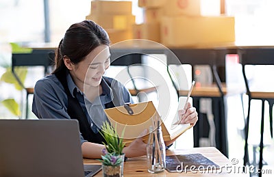 Starting Small business entrepreneur SME freelance,Portrait young woman working at home office, BOX,smartphone,laptop, online, Stock Photo