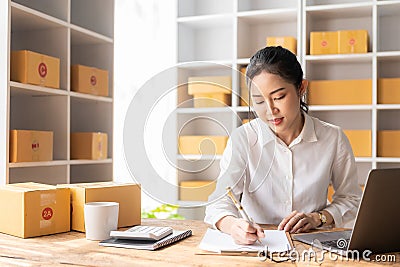 starting a small business SME Business Owner Asian female entrepreneur works on receipt boxes Stock Photo