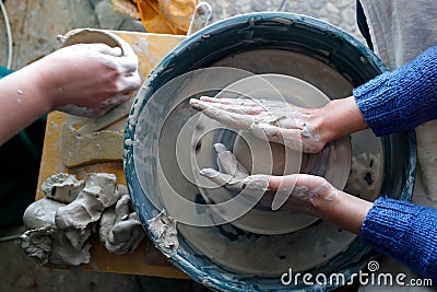 Starting work on a potter`s wheel. top view of the hands of a potter during work Stock Photo