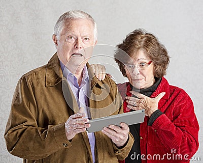 Startled Couple with Tablet Stock Photo