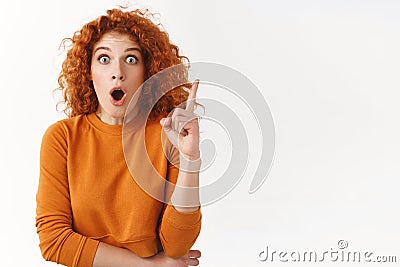 Startled excited redhead gorgeous woman have excellent idea, female coworker sharing thoughts with team, gasping open Stock Photo