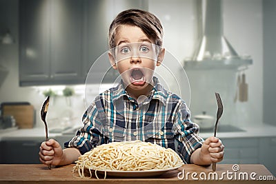 Startled yound boy with noodles Stock Photo