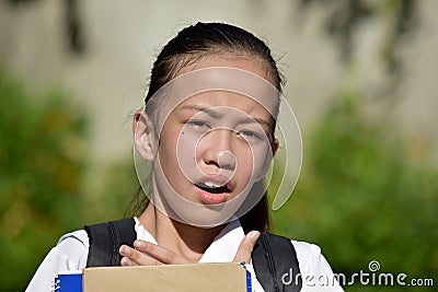 A Startled Young Filipina Female Student Stock Photo