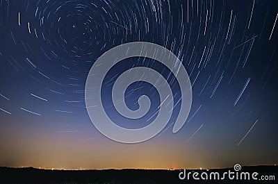 Startrail landscape of moving stars during the night of the Perseid meteor shower Stock Photo