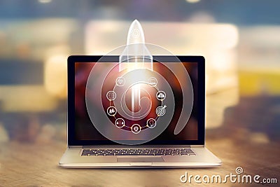 Startup concept. Laptop on wooden table and icon network Stock Photo