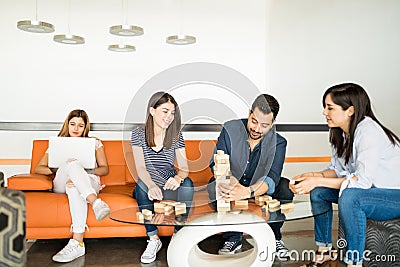 Startup employees playing jenga in break Stock Photo