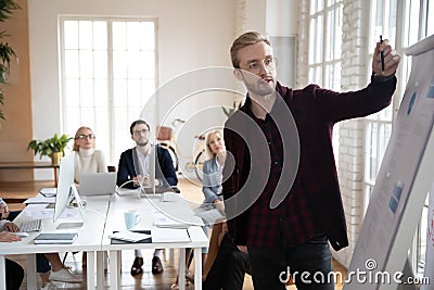 Startup leader presenting charts to his team in meeting room Stock Photo