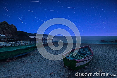 Stary Night and Perseid Meteor Shower on Beach Stock Photo