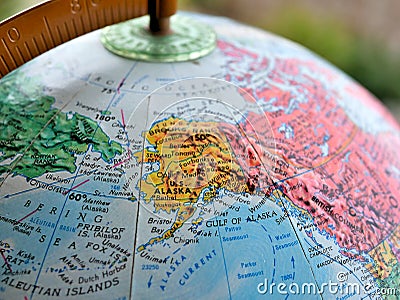 State of Alaska focus macro shot on globe map for travel blogs, social media, website banners and backgrounds. Stock Photo