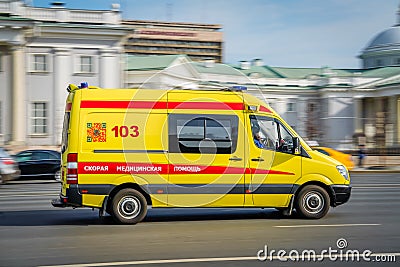 A state ambulance yellow van speeds along a wide city street. Motion blur. Moscow, Russia - April 5, 2019 Editorial Stock Photo