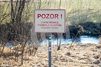 State border warning signs `Beware! state borders run across a border watercourse` Editorial Stock Photo
