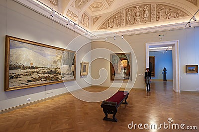 The State Russian Museum. One spectator in the hall. The girl is slender. Sculptures, bench, sculpting, luxurious decoration Editorial Stock Photo