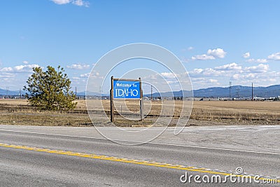 A state Welcome to Idaho roadside sign in the Coeur d`Alene region of Northern Idaho, United States of America Editorial Stock Photo