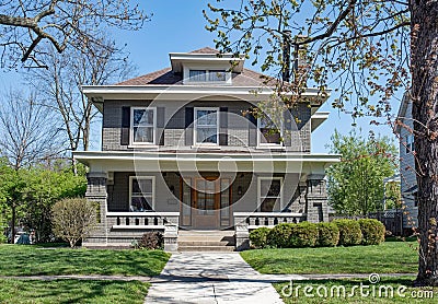 Gray Brick Craftsman Style House with Open Porch Stock Photo